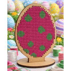 An oval-shaped, laser-cut wooden Easter egg with a grid of small, uniform holes for cross-stitching.