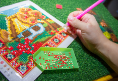 Close-up of diamond painting drills on adhesive canvas